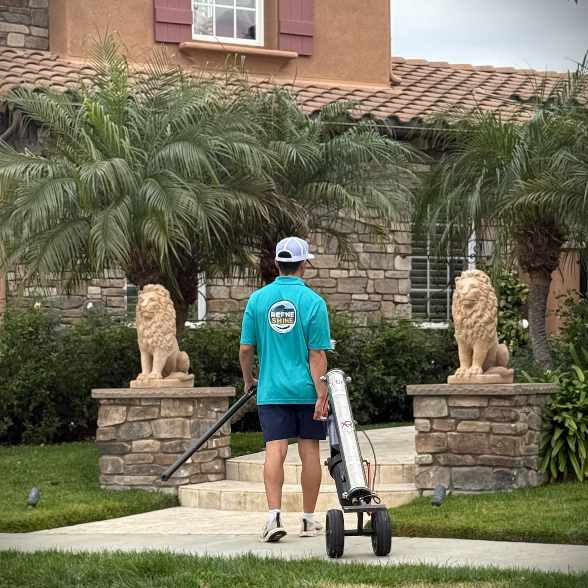 Modern home with a Toyota truck parked in the driveway, a person walking toward the entrance